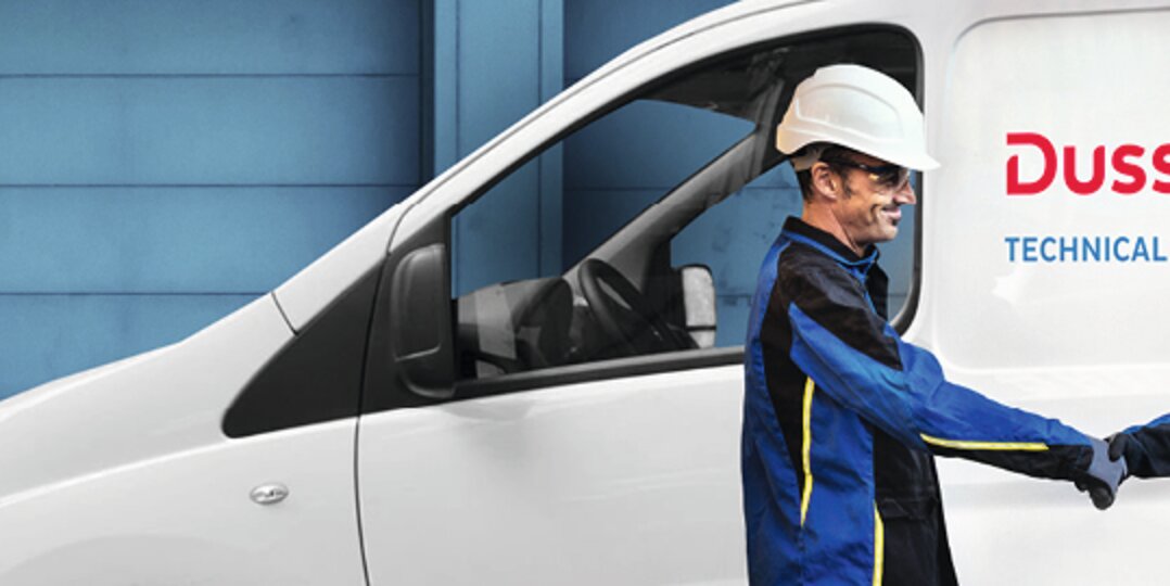 Zwei regelmatic Mitarbeiter vor Auto